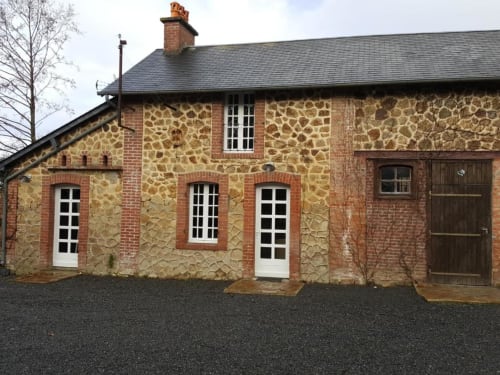 Le Petit Logis at Le Petit Lustucru, a charming brick and stone cottage in Avranches with white-framed windows and garden