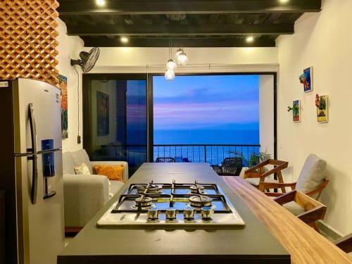Modern CUBO apartment kitchen with ocean view at Anita Ocean View, Puerto Vallarta featuring gas stove, refrigerator and