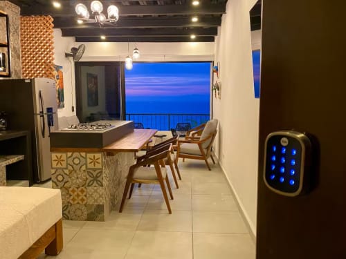 Anita Ocean View CUBO apartment in Puerto Vallarta with ocean view balcony, modern kitchen, dining area, and evening sea