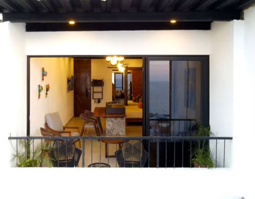 CUBO apartment balcony at Anita Ocean View Puerto Vallarta with sea views, modern furniture, and ocean backdrop at dusk