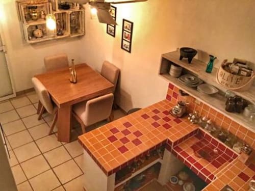 Anita Ocean View apartment kitchen and dining area in Puerto Vallarta with orange tile counters and wooden table