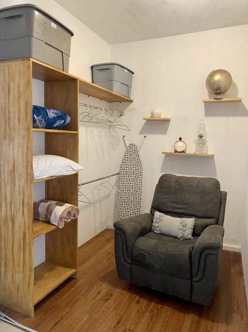Cozy BURBUJA apartment at Anita Ocean View Puerto Vallarta with wooden shelving, dark chair, and ironing station