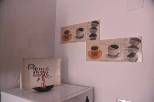 Benavente rental apartment kitchen decor with coffee-themed wall art, home sweet home tray, and minimalist design