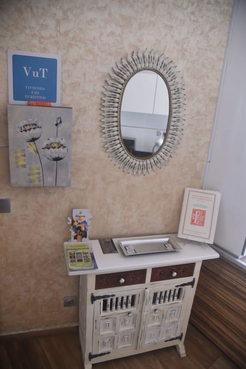 Benavente rental property desk area with decorative mirror, VuT sign, and stylish white furniture