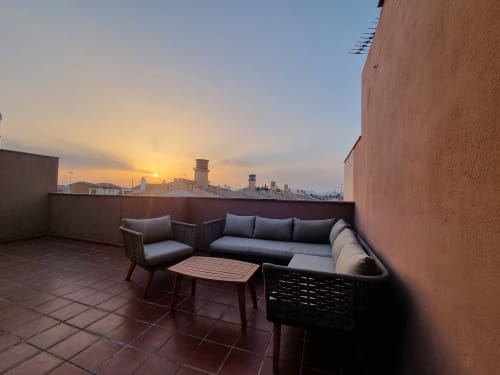 Rooftop terrace at CTH Granada with modern seating overlooking Granada city skyline at sunset