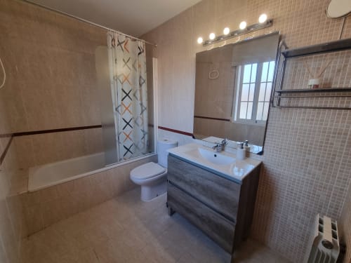 Modern bathroom in Boabdil House cottage at CTH Granada with vanity, toilet, shower, and illuminated mirror