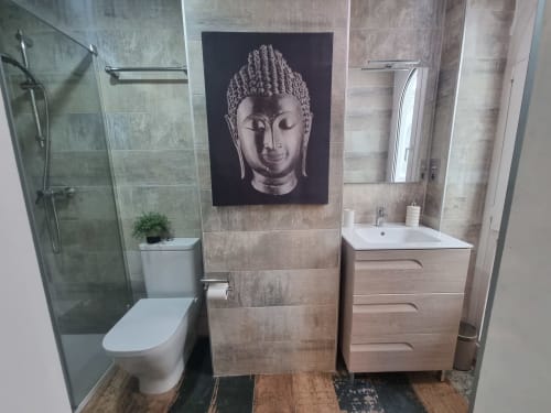 Baño moderno en el Penthouse CTH Granada Gracia con inodoro, lavabo, ducha y retrato de Buda sobre azulejos