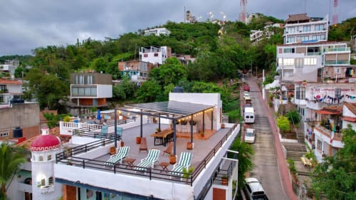 Anita Ocean View rooftop terrace in Puerto Vallarta with lounge chairs, pergola, and hillside views
