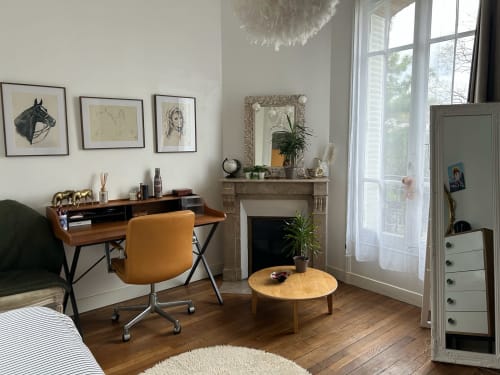 Elegant villa bedroom with wooden desk, fireplace, and garden view at Locavilla in Colombes