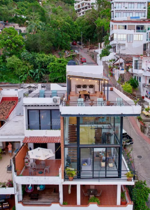 Anita Ocean View Puerto Vallarta aerial view showing modern beachfront property with terraces, lush hillside surroundings