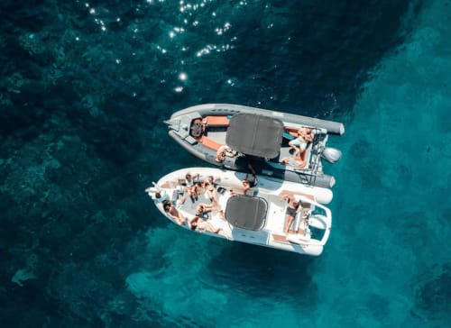 Aerial view of two boats with guests in turquoise Mediterranean waters near Hôtel Manon in Marseille