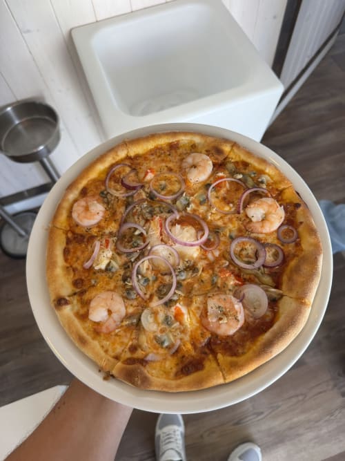 Seafood pizza with shrimp and onions served at Costa Alentejana, Zambujeira do Mar