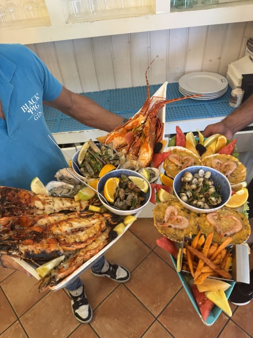 Grilled seafood platter at Costa Alentejana, Zambujeira do Mar featuring lobster, fish, clams and shrimp