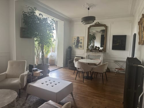 Elegant living room in Villa Saint-Hilaire, Locavilla with fireplace, garden view, dining area, and modern furnishings