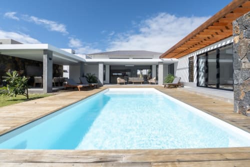 La Villa Boz: Modern villa with rectangular swimming pool, wooden deck, stone accents, and covered patio in Saint Philbert de