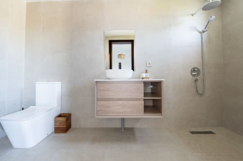 Modern bathroom with floating vanity, vessel sink, and walk-in shower at La Villa Boz villa in Saint Philbert de Bouaine.