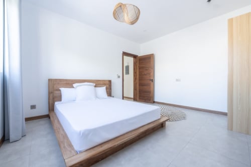 Spacious bedroom at La Villa Boz villa in Saint Philbert de Bouaine with wooden bed, white linens, and modern amenities