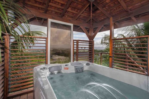 Heated jacuzzi on wooden deck with panoramic views at Paradise Location villa in Martinique