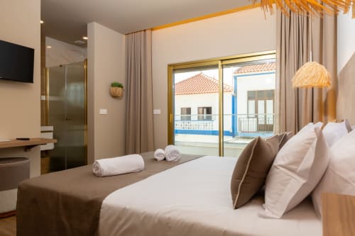 Deluxe double bedroom at Costa Alentejana in Zambujeira do Mar with sea-view balcony, modern amenities, and coastal