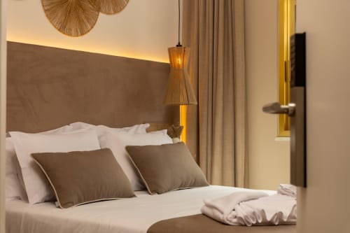 Modern double bedroom at Costa Alentejana B&B in Zambujeira do Mar with brown headboard and pendant lighting