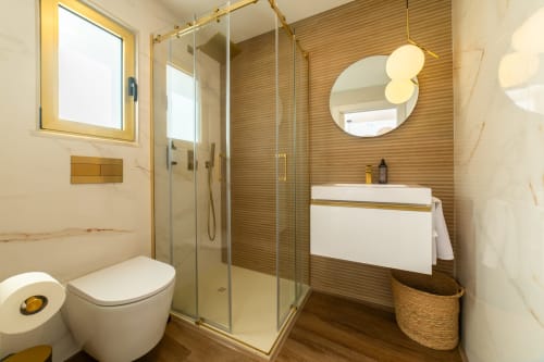 Modern bathroom with walk-in shower, white vanity, and wooden accents at Alojamento Costa Alentejana, Zambujeira do Mar