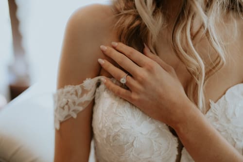 Bride wearing lace wedding dress and engagement ring at Paradise Location hotel in Fort-de-France