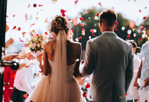 Bride and groom exchanging vows with rose petals falling at Paradise Location wedding in Fort-de-France