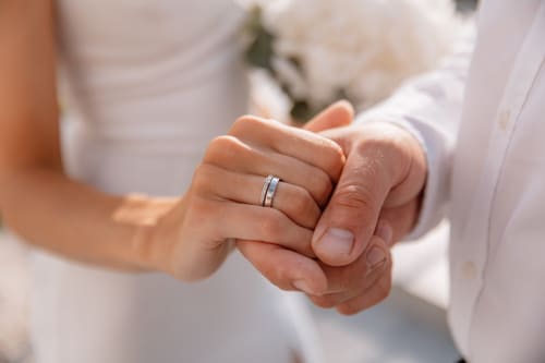 Newlyweds' hands displaying wedding rings at Paradise Location in Fort-de-France