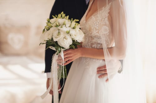Bride holding white floral bouquet at Paradise Location wedding venue in Fort-de-France