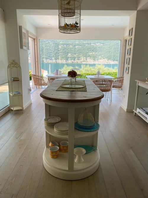 Verdolivo lakeside kitchen with island storage, modern dining area, and panoramic Lake Iseo views