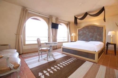 Junior Suite at Hotel San Giovanni Resort in Saluzzo with mountain views, elegant bed, seating area, and arched windows
