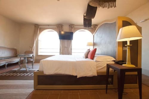 Spacious junior suite at Hotel San Giovanni Resort in Saluzzo with king bed, mountain views through large windows, and modern