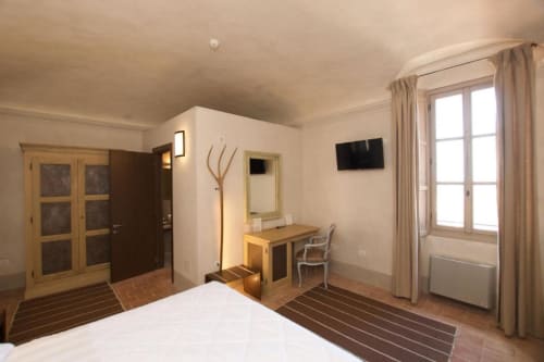 Superior Double Room at Hotel San Giovanni Resort in Saluzzo featuring a bed, desk, TV, and garden view from the terrace