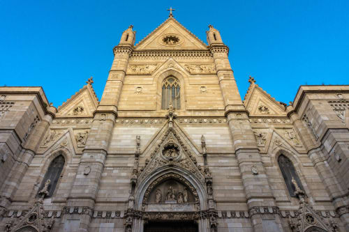 Historic stone church facade with ornate Gothic architecture in Naples, near I Migliori Artisti