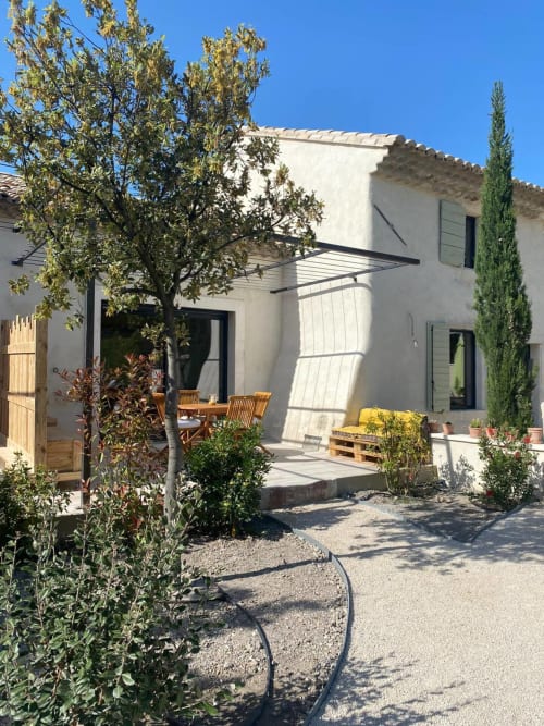 Modern Provençal cottage at Mas St André with shaded patio, wooden dining table, and Mediterranean garden in Saint-Andiol,