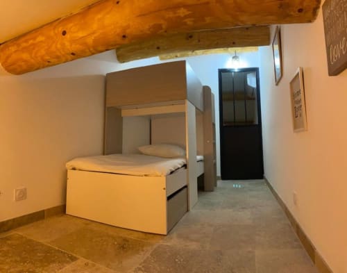 Bedroom in Mas St André cottage, Provence with canopy bed and wooden beams