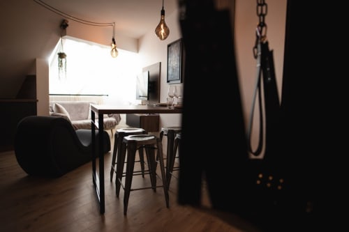 Modern romantic apartment in Vannes with bar seating, pendant lighting, and contemporary furnishings overlooking the city
