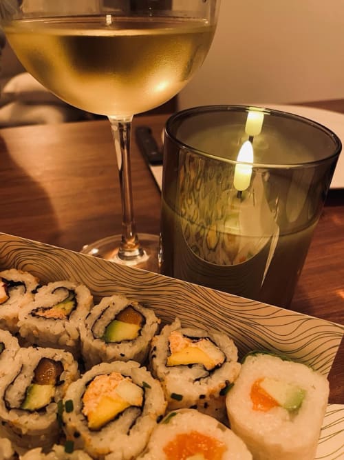 White wine, sushi rolls, and cocktail at Le Lien romantic apartment in Vannes