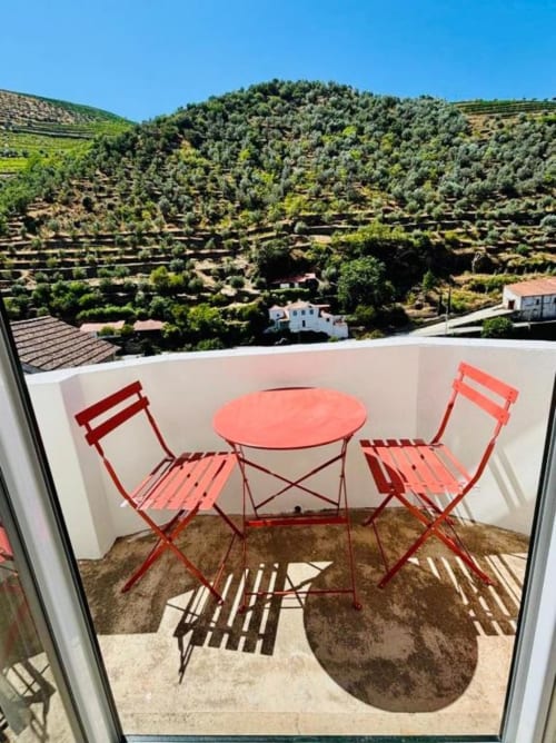 Red bistro set on Tinta Barroca balcony with Douro Valley vineyard views, Casa Tawny, Pinhão