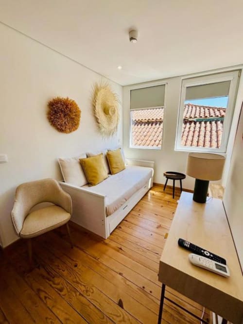 Touriga Franca suite at Casa Tawny in Pinhão featuring cream sofa, armchair, desk, and terracotta roof views