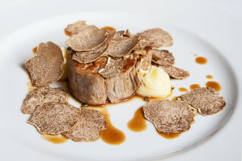 Plato gourmet con trufas laminadas y foie gras en el Hotel San Giovanni Resort de Saluzzo