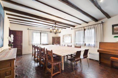 Spacious dining room at Masia Rural Ca l'Eloi Janet villa near Barcelona with wooden beams, mountain views, and rustic