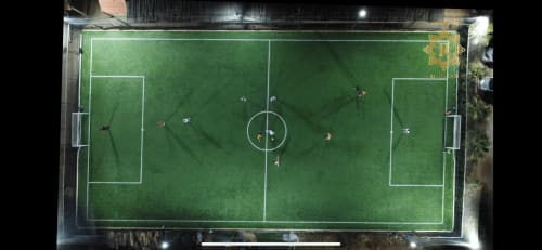 Overhead view of soccer field at Riad Gold Hôtel in Azrou, Morocco, with players during a match