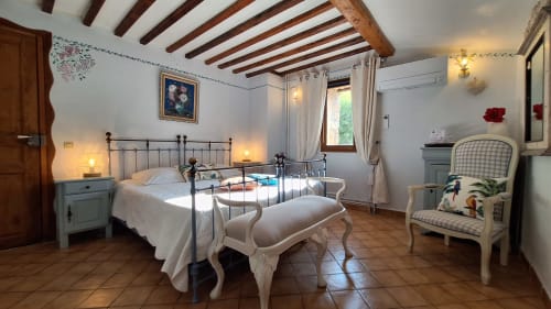 Lavender room at La Bergerie Du Moulin, Taradeau - charming bedroom with wrought iron bed, exposed beams, and elegant