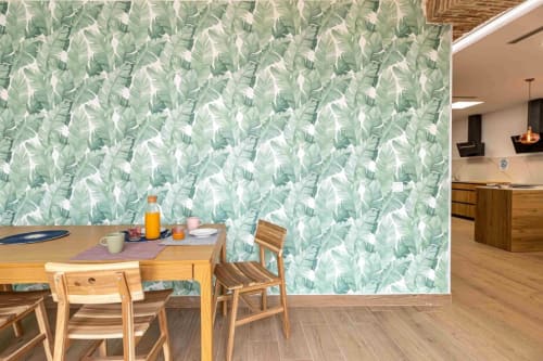 Modern dining area at Residencia Demar hotel in Godella with green leaf patterned wallpaper and wooden furniture