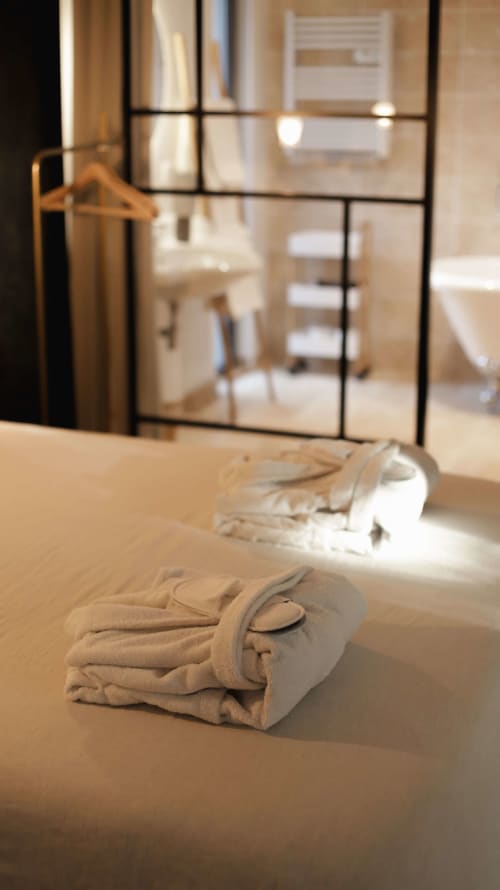 Romantic bed setup with bathrobes for private-spa weekend Vosges
