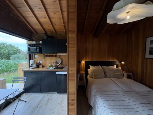 Barn Nest bedroom at Villa Várzea in Várzea featuring wooden interior, queen bed, kitchenette, and mountain views