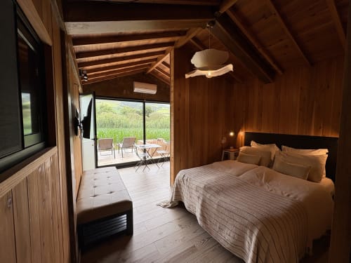 Wooden bedroom at Villa Várzea with bed, patio doors opening to countryside, Várzea Portugal