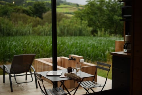 Outdoor patio at Villa Várzea with cornfield views, featuring dining table and chairs overlooking rural Portuguese