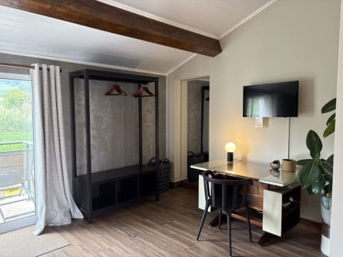 Modern bedroom at Villa Várzea with wardrobe, desk, TV, and garden view from Várzea, Portugal
